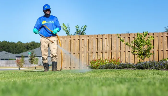 lawn tech spraying yard for pests