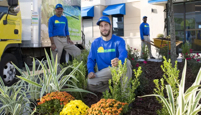 maintenance technicians working in flower bed